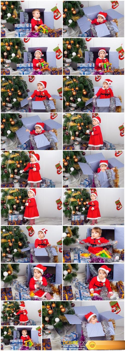 Cute little girl in Santa's suit near a Christmas tree - 19xUHQ JPEG Photo Stock