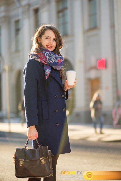 Young woman on the street with a cup of coffee in hand 12X JPEG