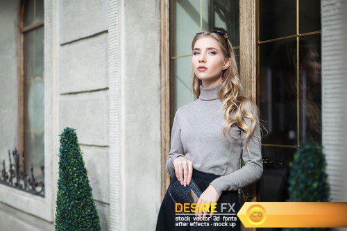 Fashionably dressed blonde is walking around the city 11X JPEG