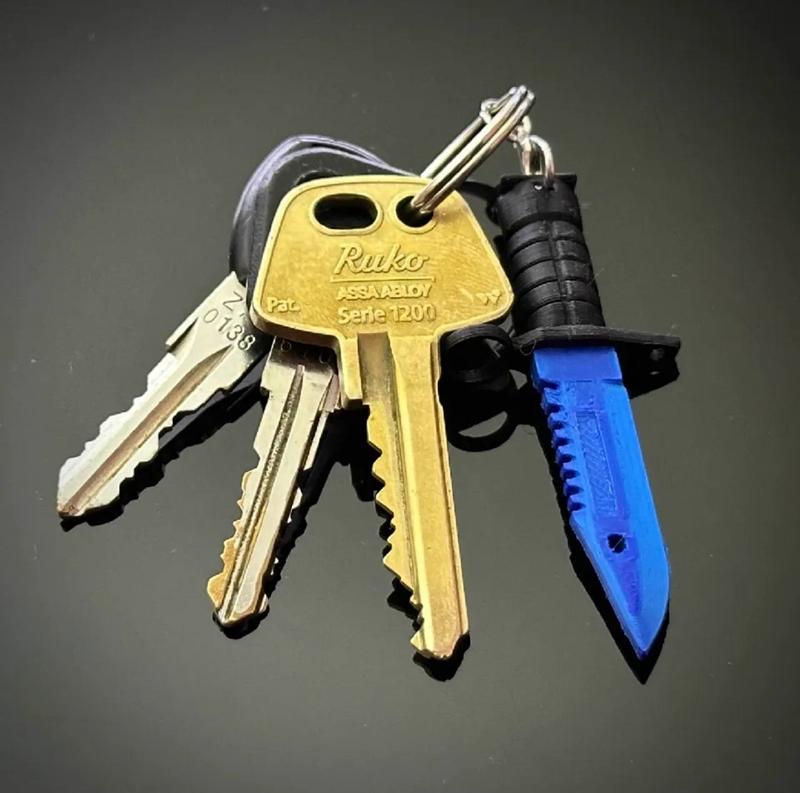 Blue 3D printed M9 Bayonet keychain charm with black handle, attached to a set of house keys.