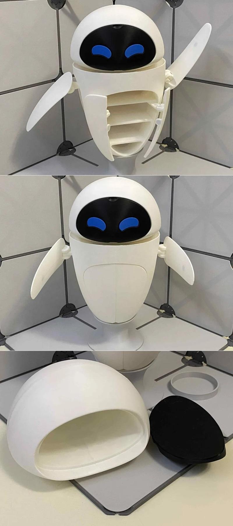 3D printed model of E.V.E. from WALL-E, showing open storage compartment, closed torso, and detached head with blue e...