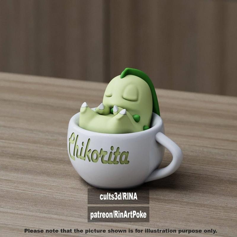3D model of a cute, green Chikorita Pokémon sleeping inside a white mug with its name on the side.