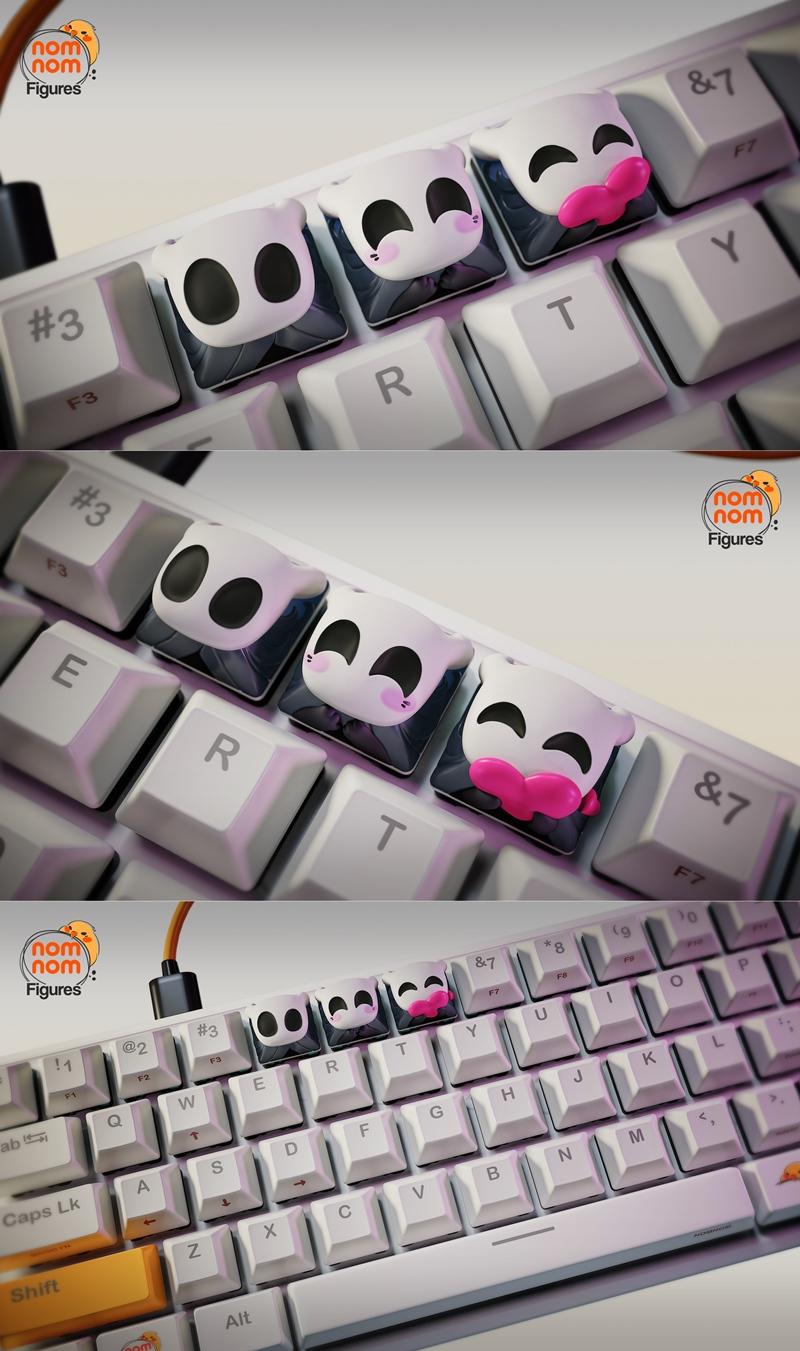 Close-up of white mechanical keyboard keycaps featuring the Hollow Knight character's face in various cute expression...
