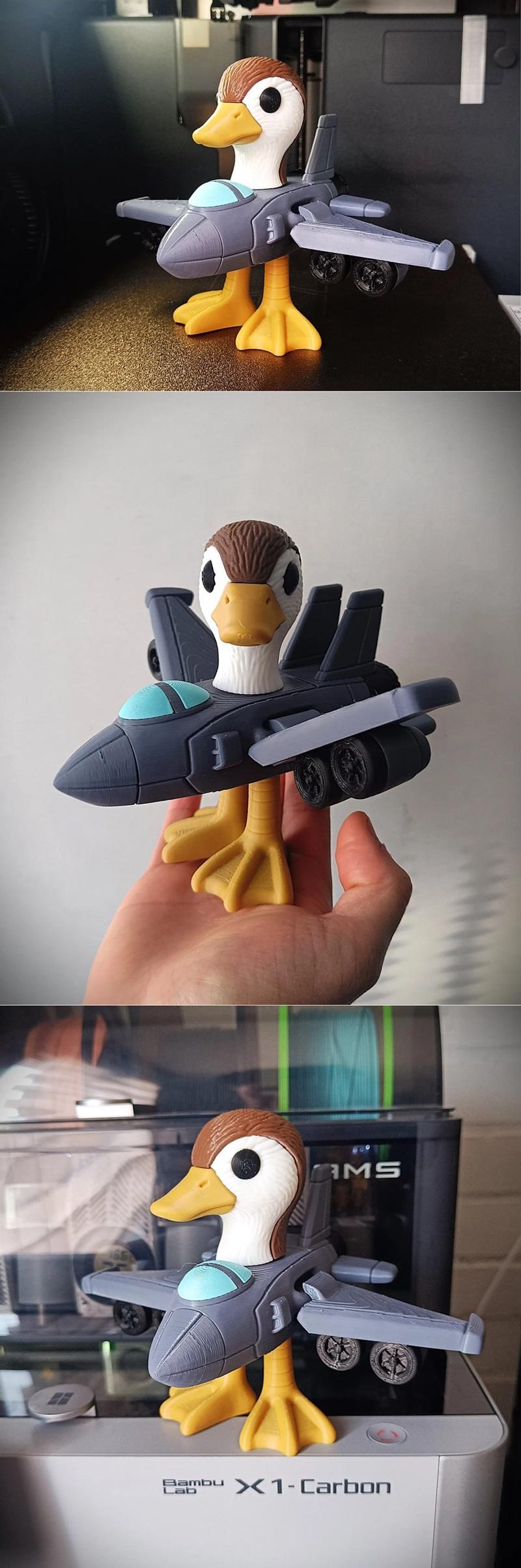 Articulated 3D print model of Bombombini Gusini, a duck with a jet fighter body, yellow feet, and gray wings.
