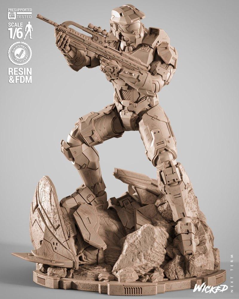 Master Chief from Halo in full armor, aiming a rifle, standing on a rocky diorama base. 1/6 scale figure by Wicked.