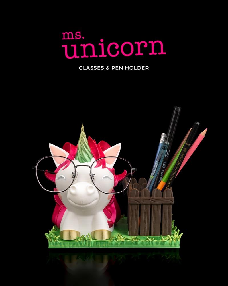 3D printable Ms. Unicorn pen and glasses holder. A white unicorn with pink mane and green horn wears round glasses an...
