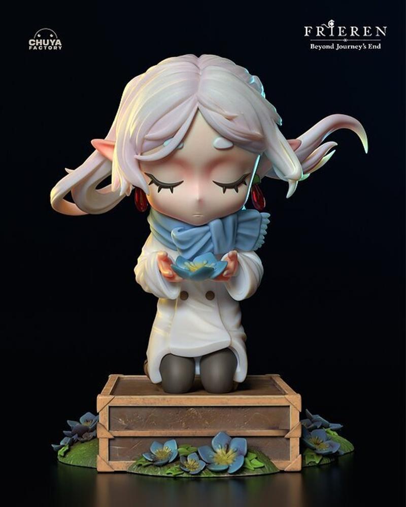 Chuya Factory Frieren chibi figure kneeling on a wooden chest, holding a blue flower. White coat, blue scarf, closed...