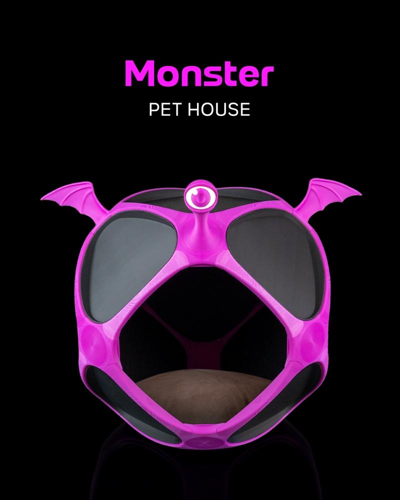 Pink monster-shaped pet house with bat wings and a single large eye, featuring an open geometric design and a brown c...