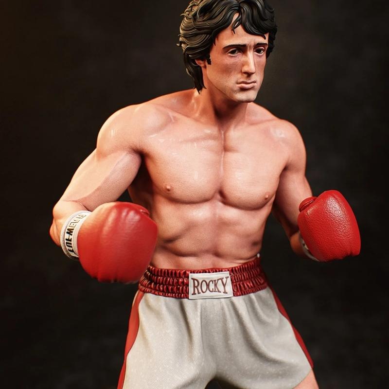 3D model of Rocky Balboa in boxing shorts and red gloves, muscular physique, determined expression, fighting stance.