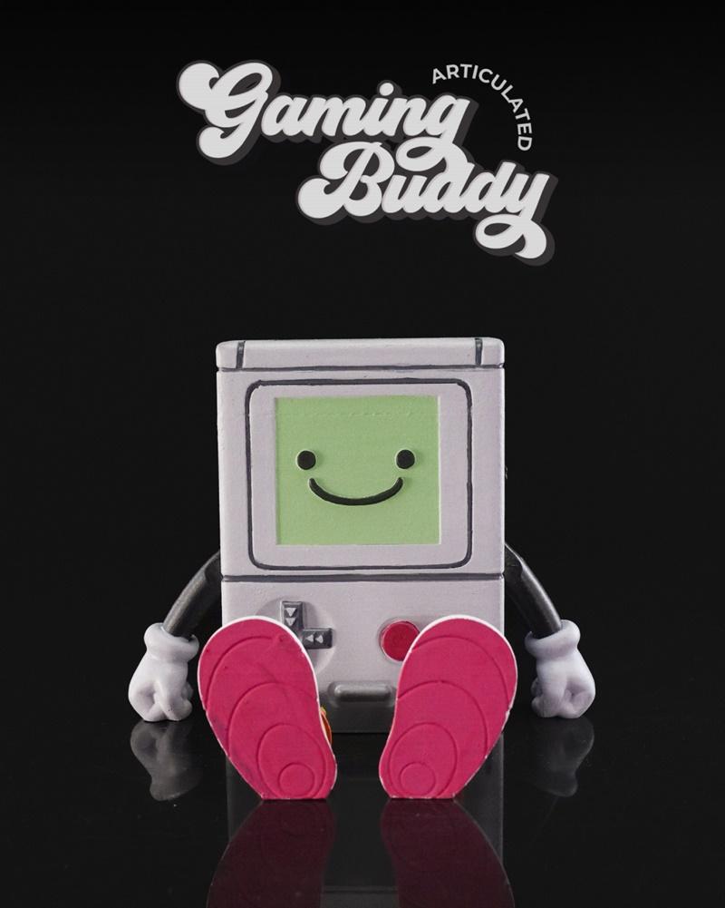 Articulated BMO figure from Adventure Time, seated with a smiling green screen, white gloves, and pink shoes. Studio...