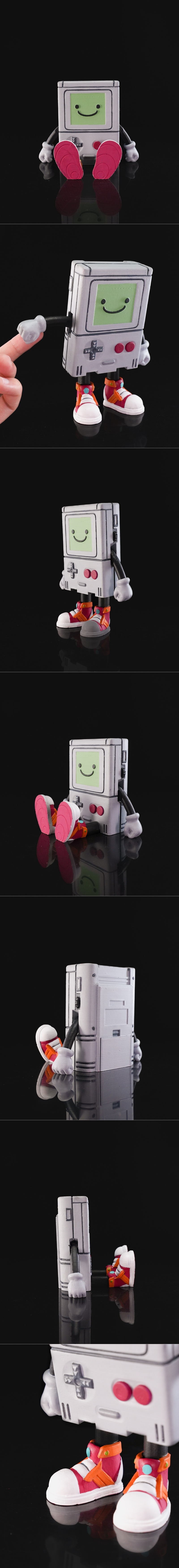 Articulated BMO figure from Adventure Time, sitting with pink shoes, grey console body, and green screen face with a...