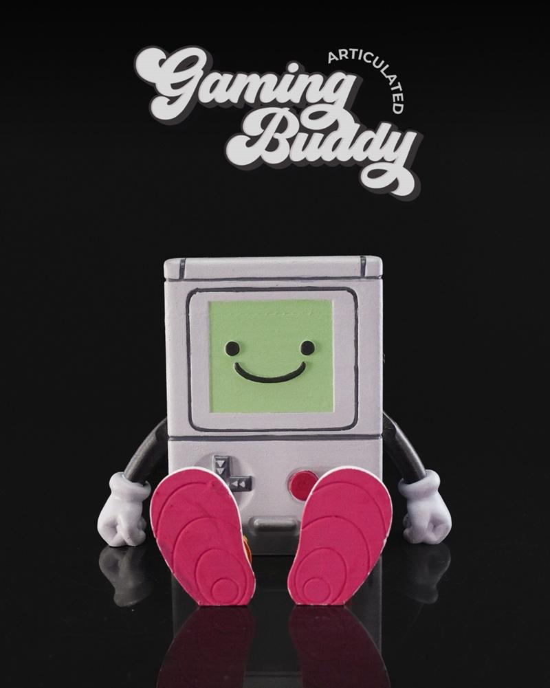 Articulated BMO figure from Adventure Time, sitting with pink shoes, grey console body, and green screen face with a...