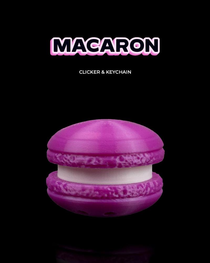 Purple macaron clicker and keychain 3D print model with white filling against a black background.