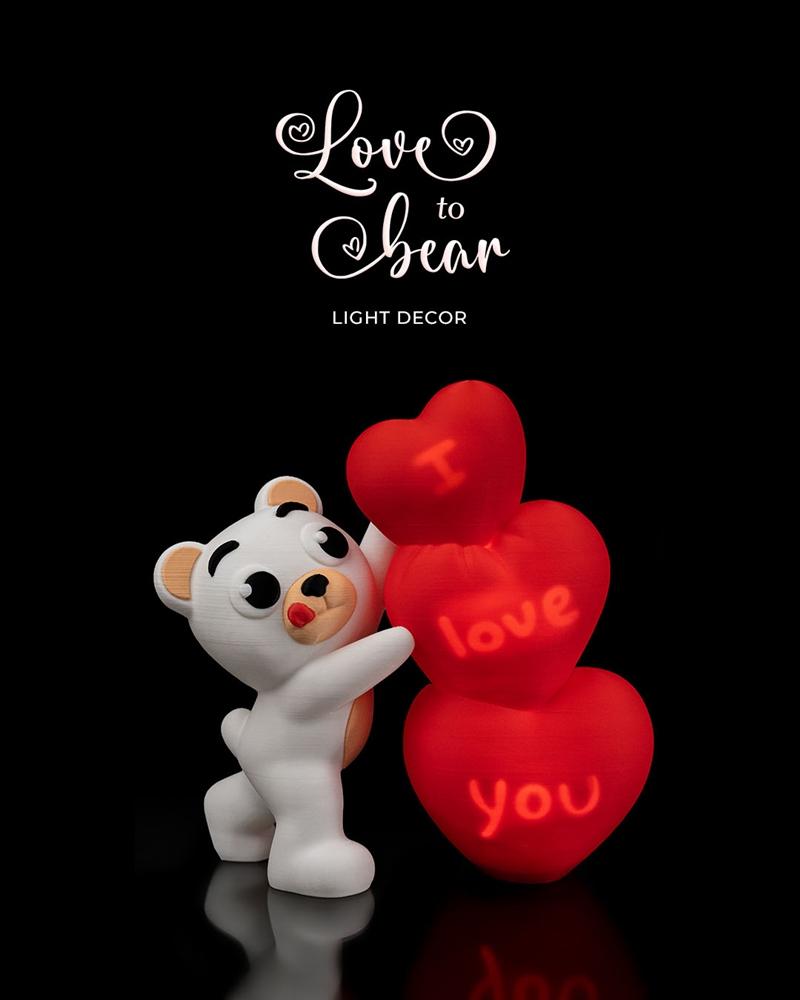 White bear figure embracing three red hearts with "I love you" text glowing inside, on a black background.