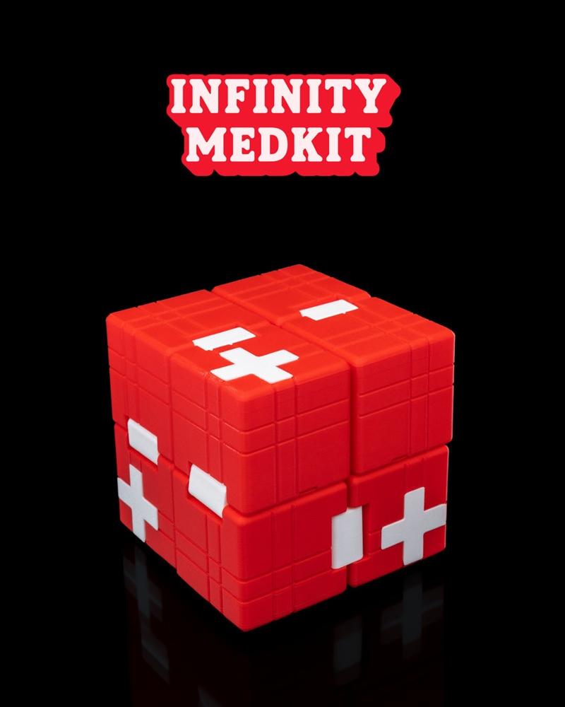 Red cube-shaped Infinity Medikit with white cross and plus symbols, designed for 3D printing.