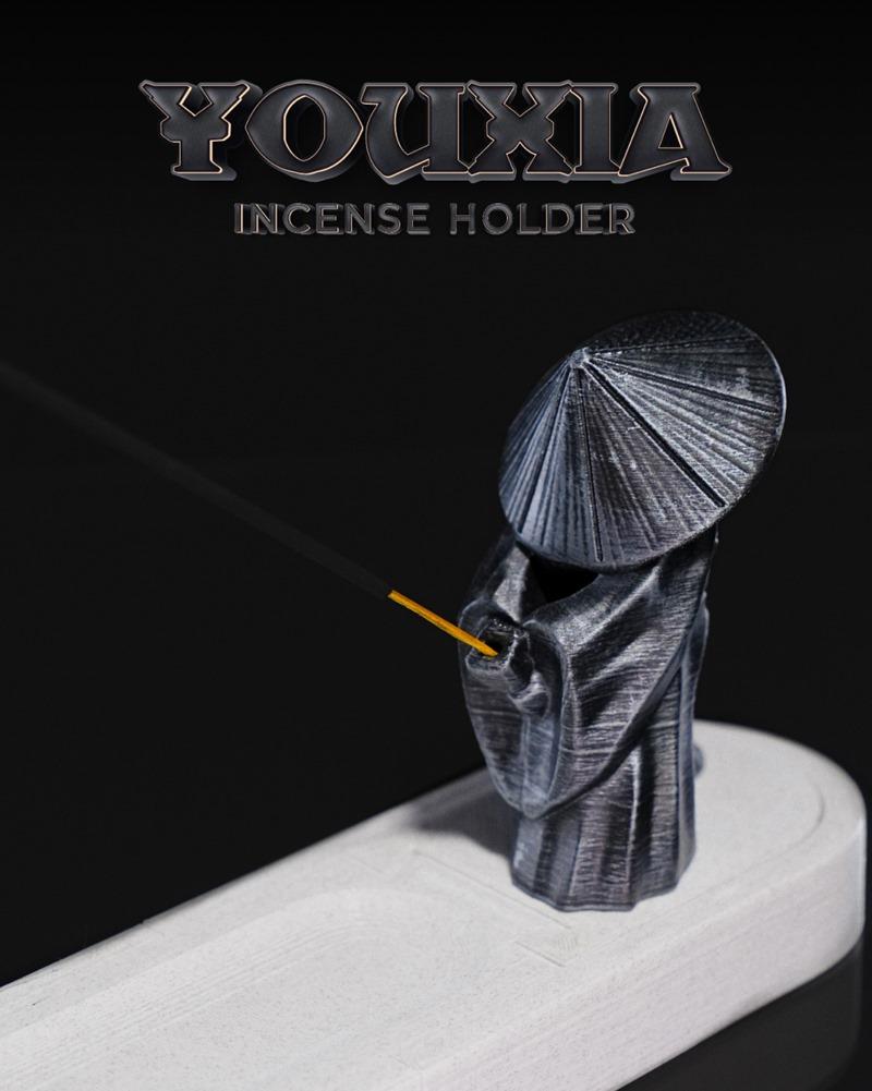 3D printable Youxia Incense Holder model featuring a figure in a conical hat and robes, holding an incense stick.
