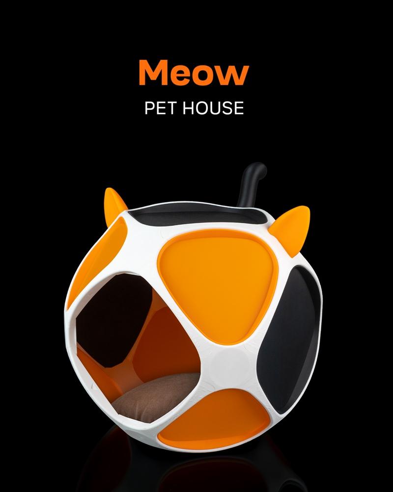 Geometric Meow Pet House with cat ears, featuring white, orange, and black panels, and a brown cushion inside, on a b...