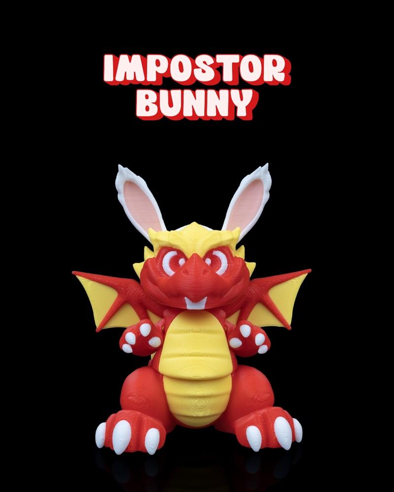 Red and yellow 3D printed figure of a dragon with white bunny ears, sitting with wings spread.
