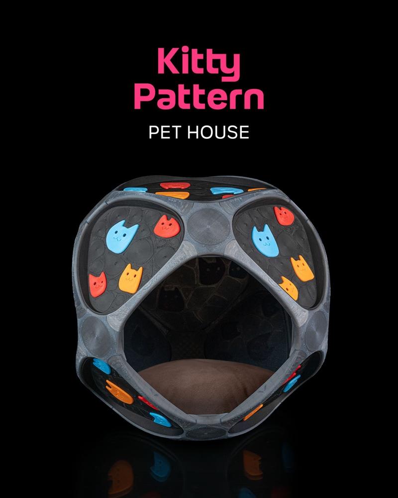Spherical pet house with geometric panels decorated with colorful cat face icons, featuring an open entrance and a br...