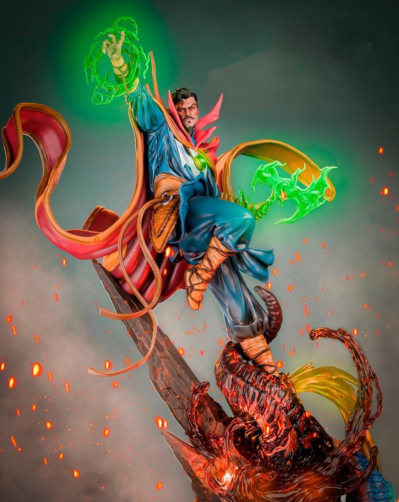 Doctor Strange figure in mid-air, casting green magic spells while battling a fiery monster. He wears his blue robes...