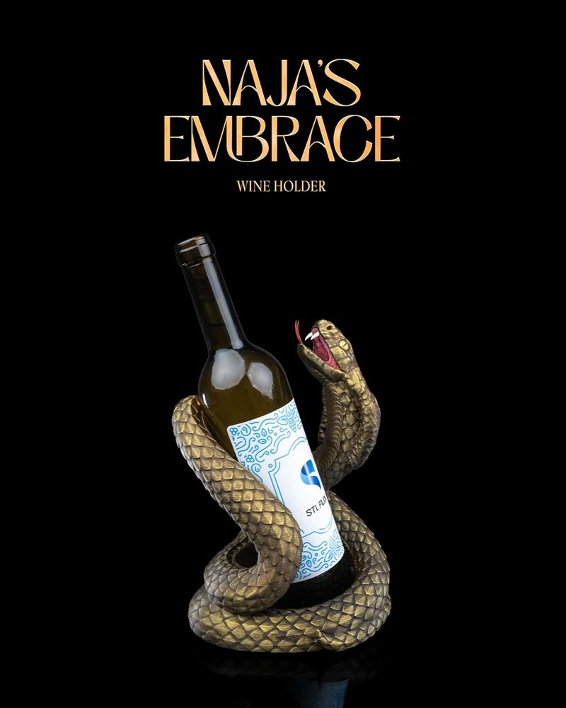 A golden snake coiled around a wine bottle, its head raised with fangs bared. The "Naja's Embrace Wine Holder&qu...