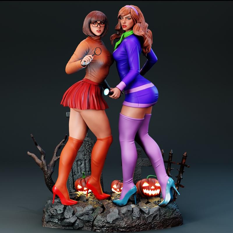 3D model of Daphne and Velma from Scooby-Doo on a Halloween-themed base with gravestones and pumpkins. Velma holds a...