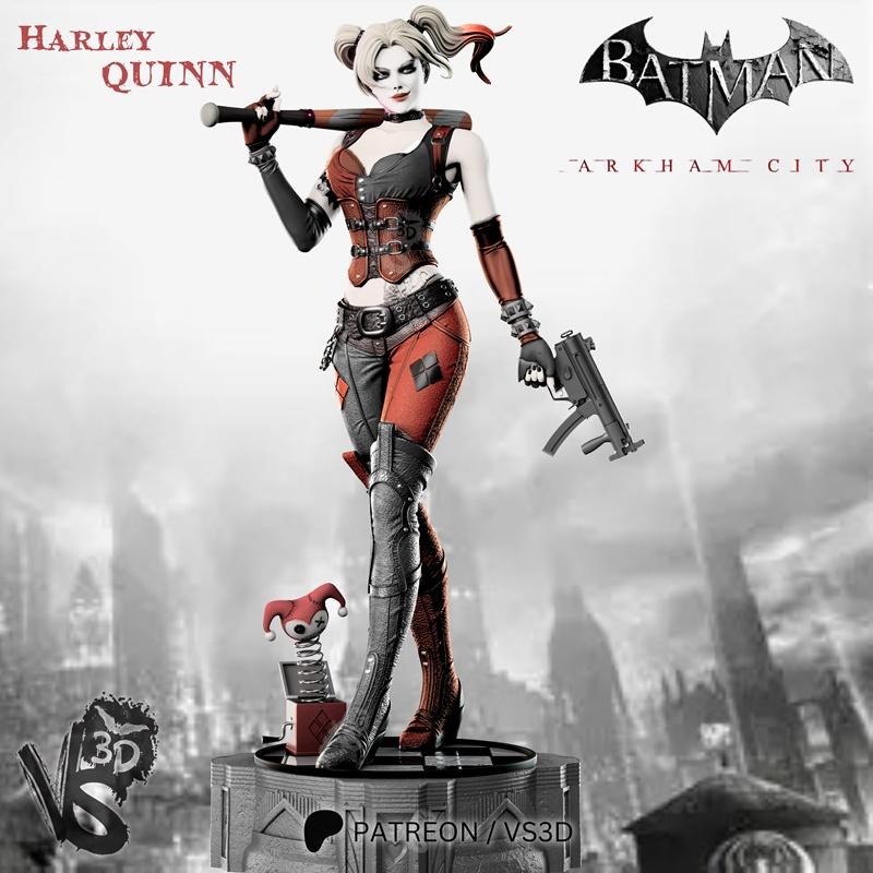 Harley Quinn figure in Arkham City costume, holding a baseball bat and pistol, with a jester jack-in-the-box at her f...