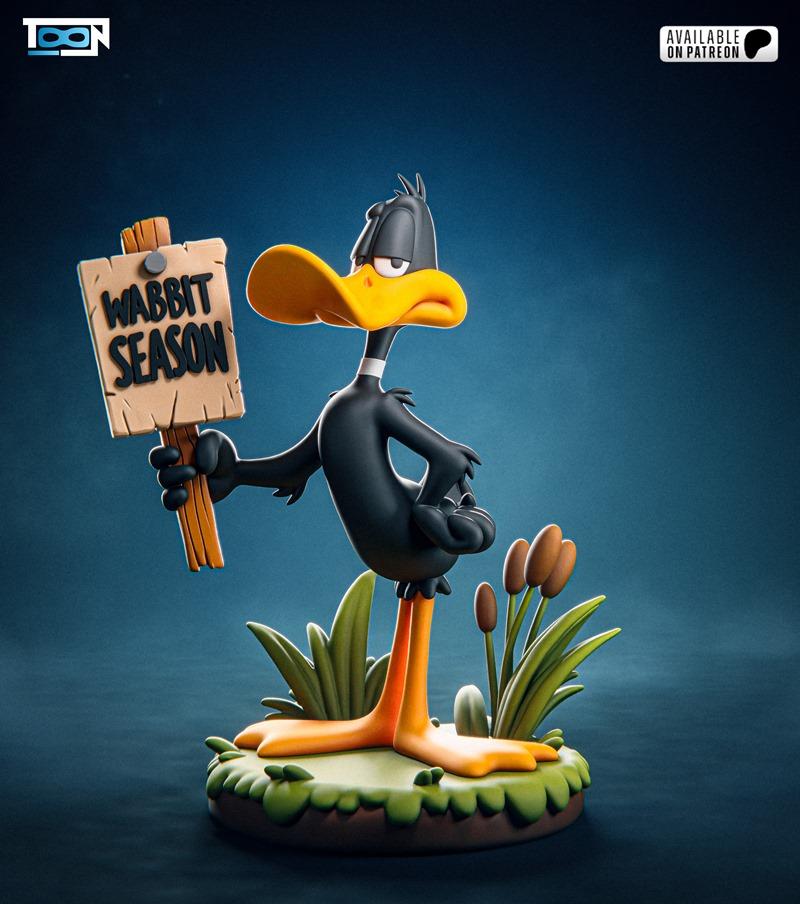 Daffy Duck figure holding a "Wabbit Season" sign, standing on a grassy base with cattails. Stylized cartoon...
