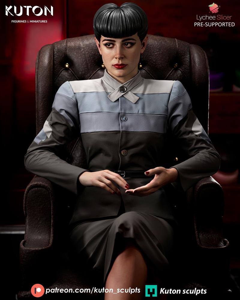 Rachel from Blade Runner seated in a leather armchair, wearing a grey and blue striped jacket and skirt. Her hair is...