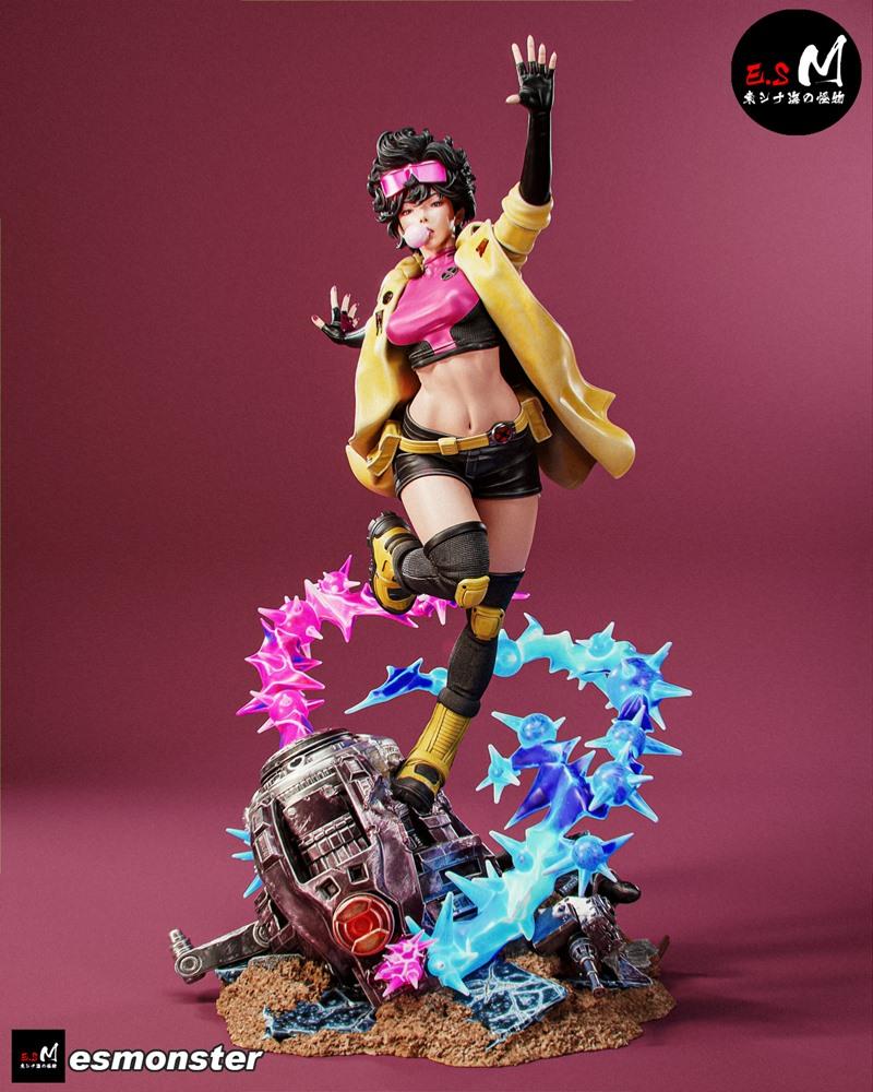 Jubilee character figure in yellow jacket and pink top, mid-jump with energy blasts, standing on rubble. E.S Monster...