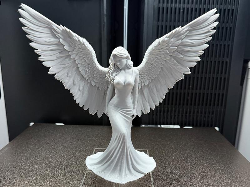 Elegant angel figure with large, spread wings and a flowing gown, detailed 3D model.