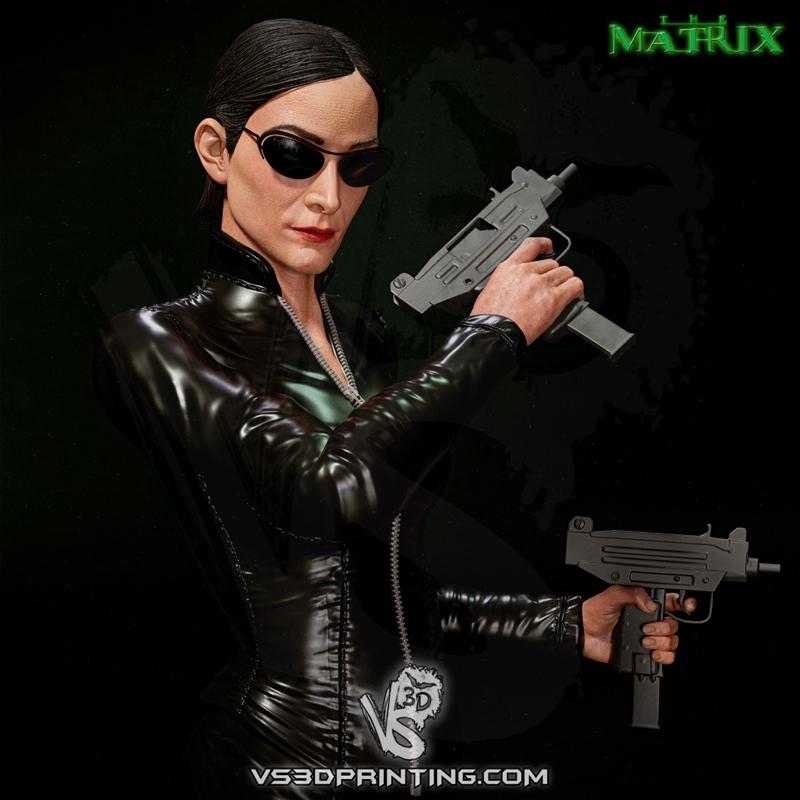 VS3D Trinity figure from The Matrix, wearing black leather, sunglasses, and holding two submachine guns.