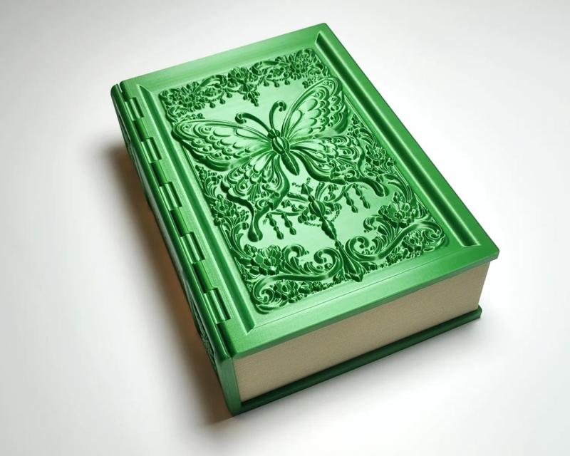 Green 3D printed secret storage book with ornate butterfly and floral carvings on the cover, featuring a hinged lid.