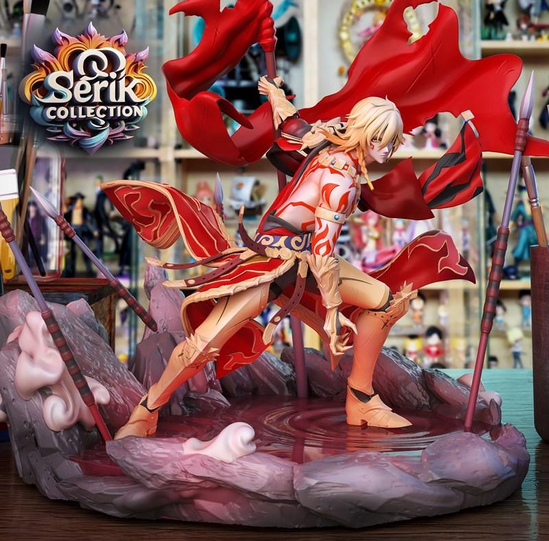 Mydei figure in dynamic pose, wearing red and gold armor with a flowing red cape, standing on a rocky base with spear...