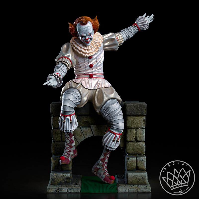 Pennywise the clown statue, seated on a stone structure, wearing a ruffled collar, white and pink suit, and red-laced...