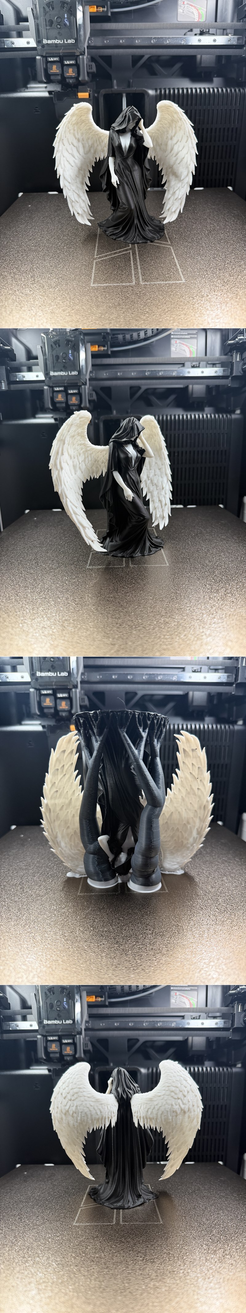 3D printed figure of a hooded female angel with large white wings, wearing a flowing black gown.