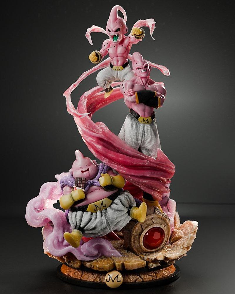 Three Majin Boo figures from Dragon Ball in different forms, posed dynamically on a rocky base with pink energy effec...