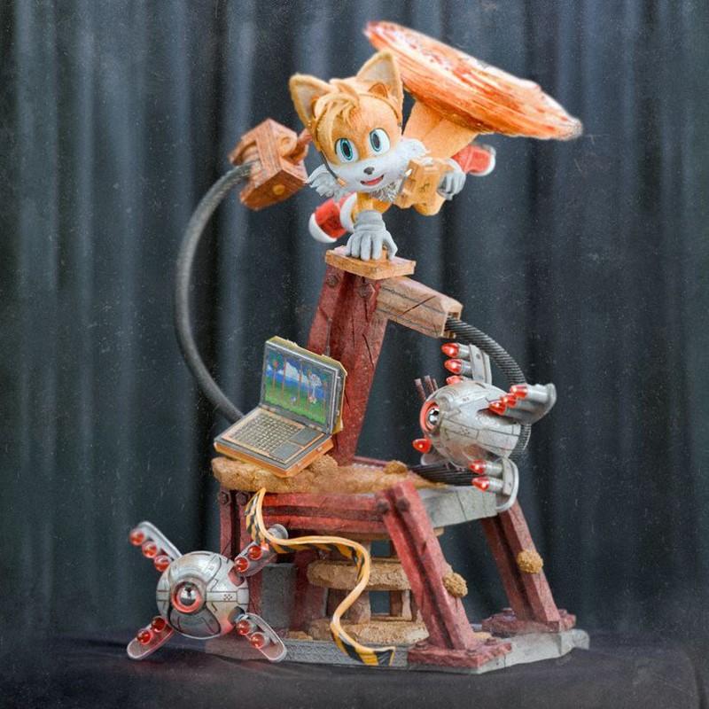Tails the fox character figure from Sonic the Hedgehog, posed dynamically on a wooden and metal structure with a lapt...