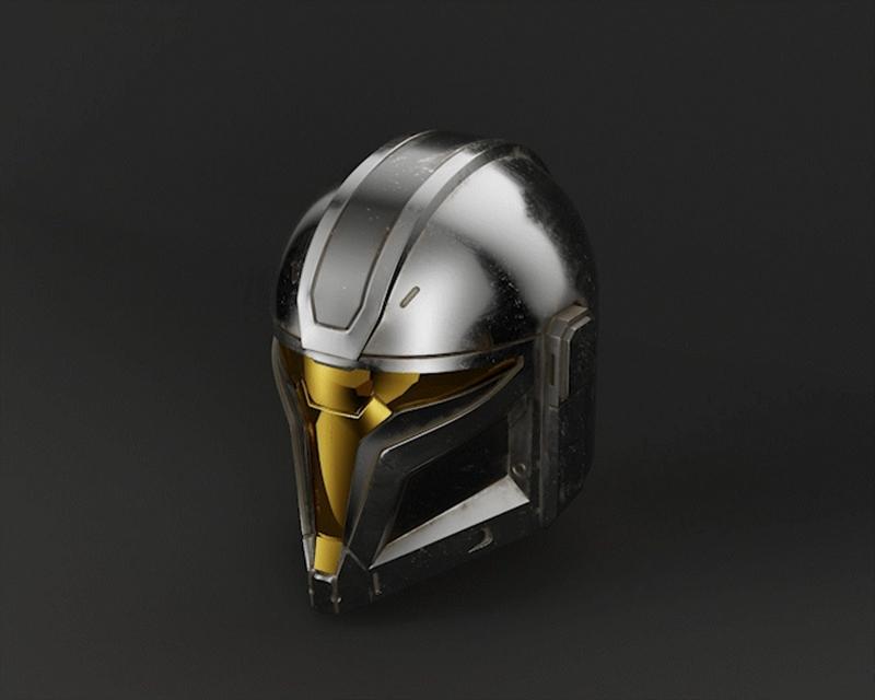 3D printable model of a Mandalorian helmet with silver and gold finish, featuring a distinctive visor and segmented a...