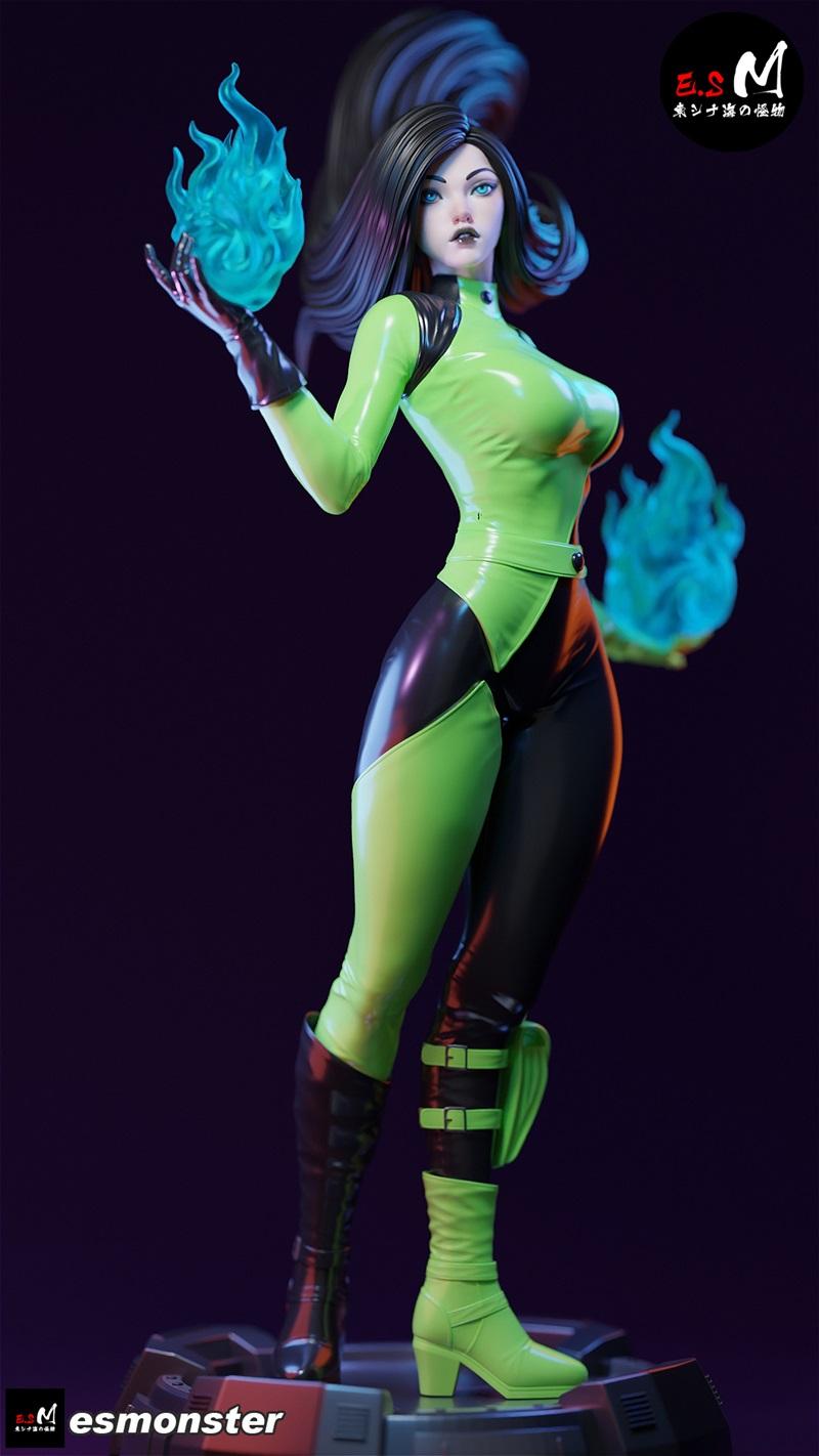Shego figure in a green and black bodysuit, conjuring blue energy blasts with both hands, standing on a detailed base.