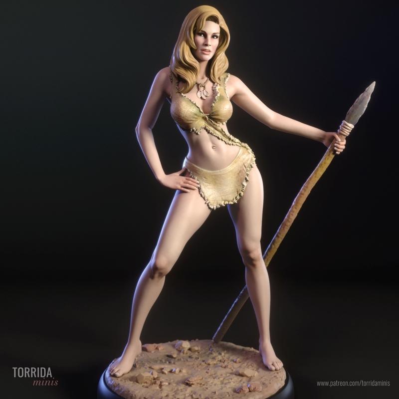 Loana, a cavewoman character, stands holding a spear. She wears a minimal tribal outfit and stands on a rocky base. T...