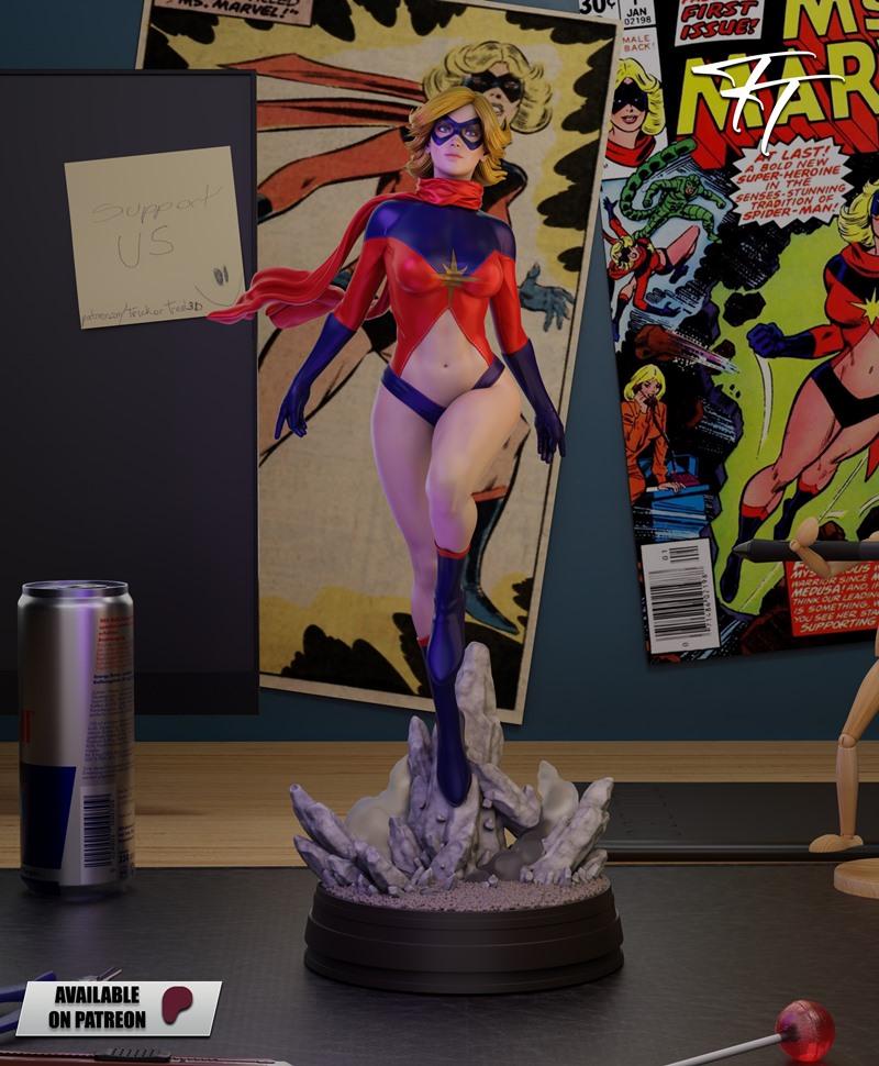 Classic Ms. Marvel 3D model figure in red and blue costume with red scarf and mask, posed heroically on a rocky base,...