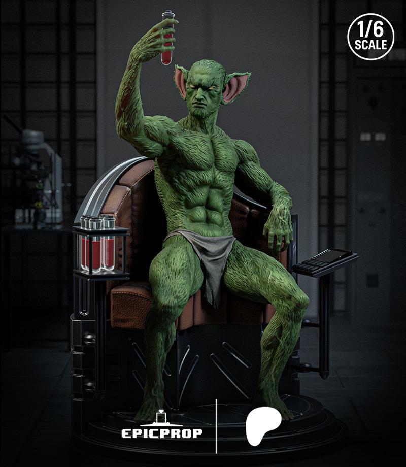 1:6 scale 3D printable figure of a green-skinned, muscular humanoid named Jackal, seated in a chair holding a test tube.