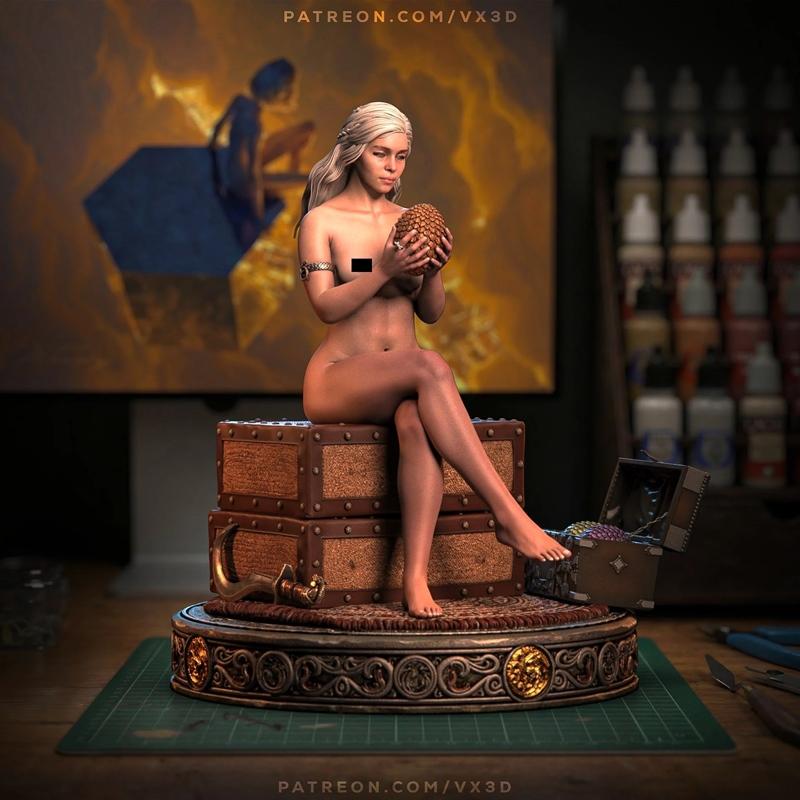 Nude Daenerys Targaryen figure from Game of Thrones, seated on chests holding a dragon egg, with censor bar. Intricat...