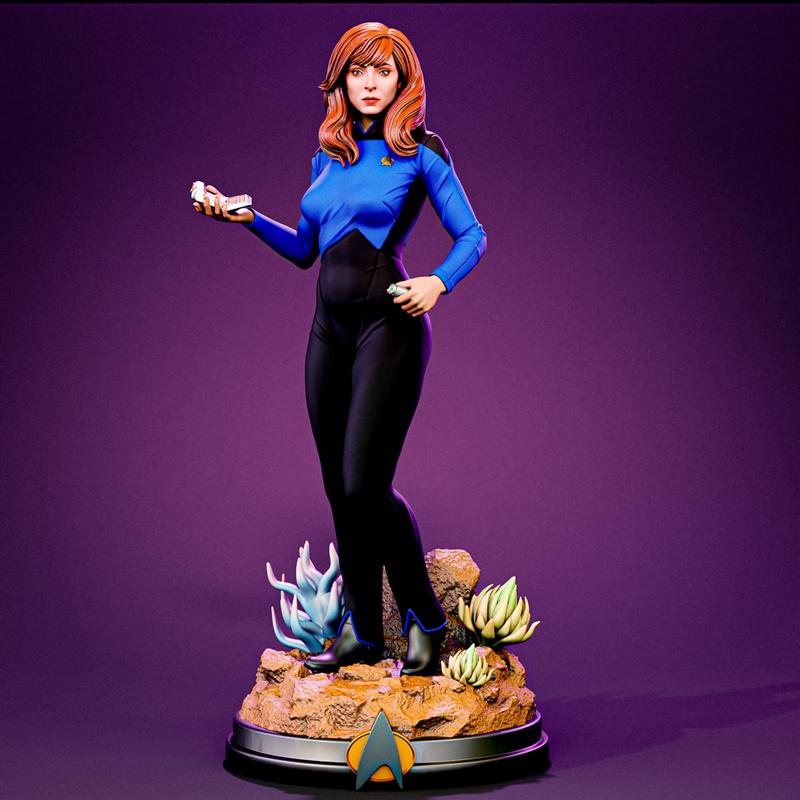 3D model of Beverly Crusher from Star Trek in a blue and black Starfleet uniform, holding a tricorder and communicato...