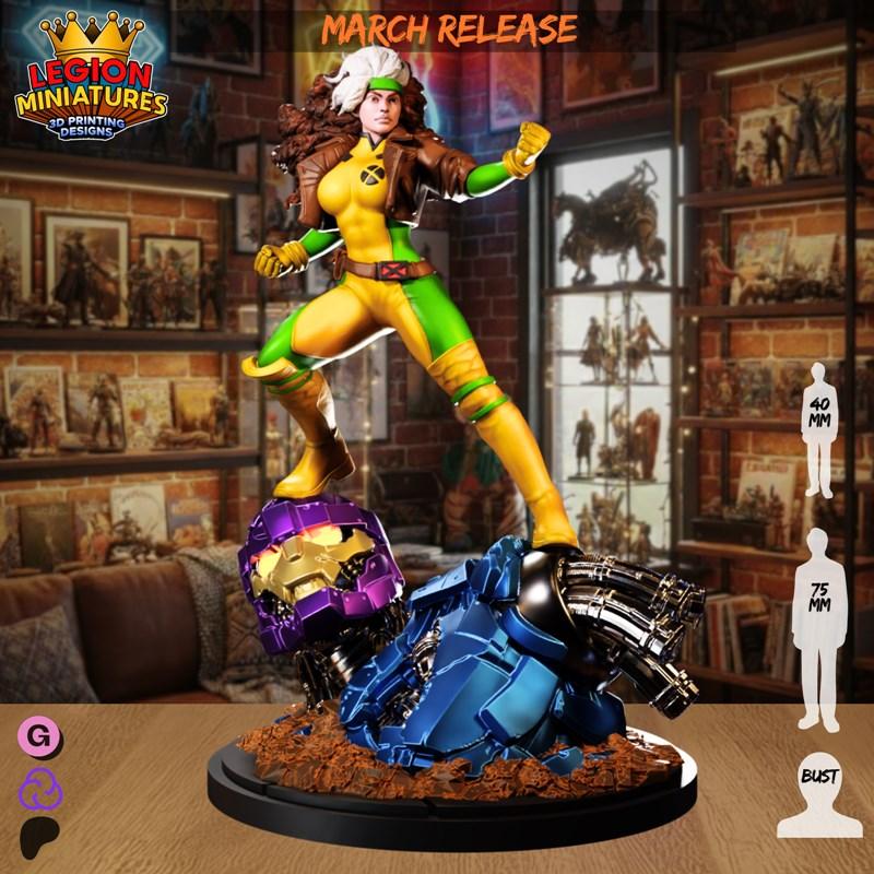 Rogue figure in yellow and green costume, brown jacket, standing on a destroyed Sentinel. Legion Miniatures 3D print...